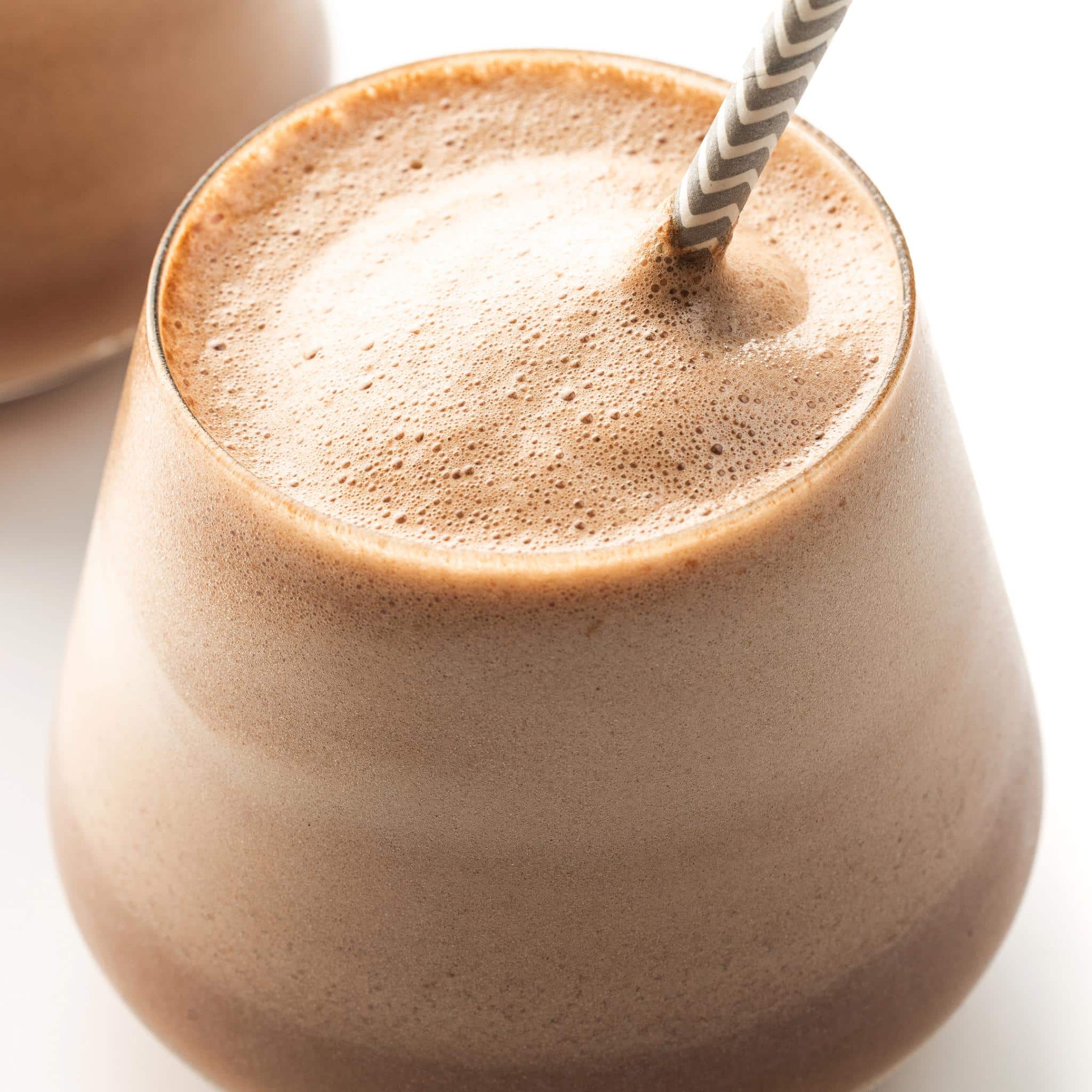 Close up of a glass filled with chocolate espresso protein smoothie.