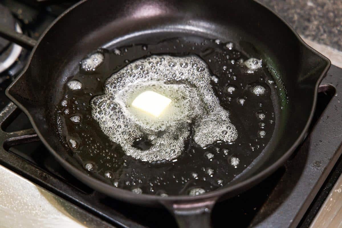 Melting butter in a cast iron skillet.